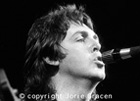 Paul pursing lips to microphone (image)